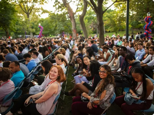 group of diverse people seated outdoors at an event