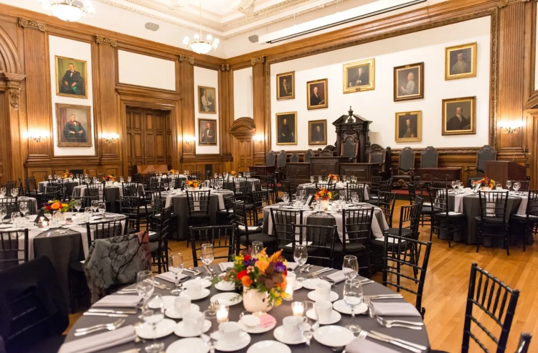 View of event space with round tables plated for a catered meal