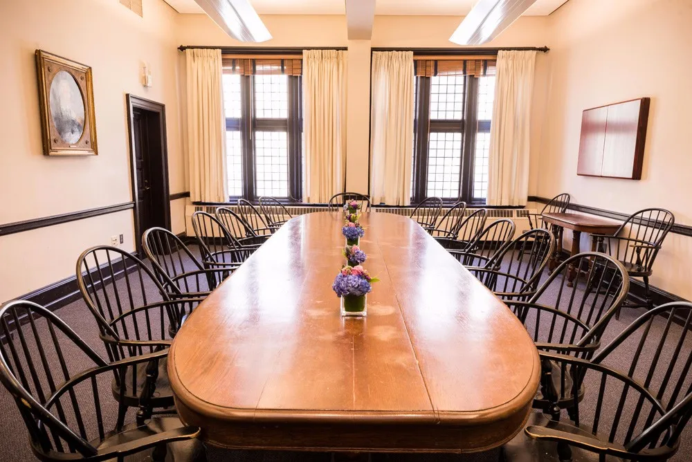 Board room table surrounded by chairs