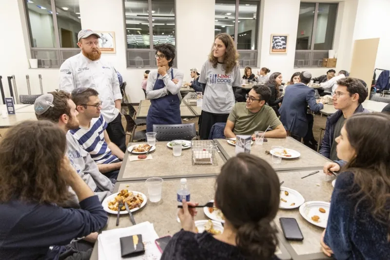 students and chef a Falk Dining Hall