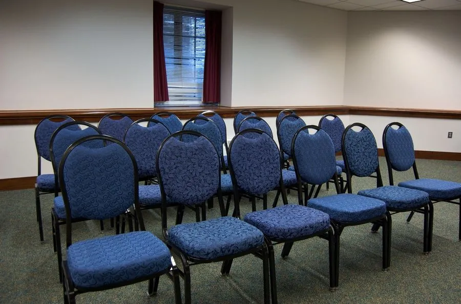 Set of blue chairs set theater style in a meeting room