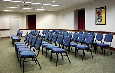 Meeting room set with blue chairs theater style