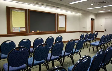 Meeting room set with blue chairs theater style