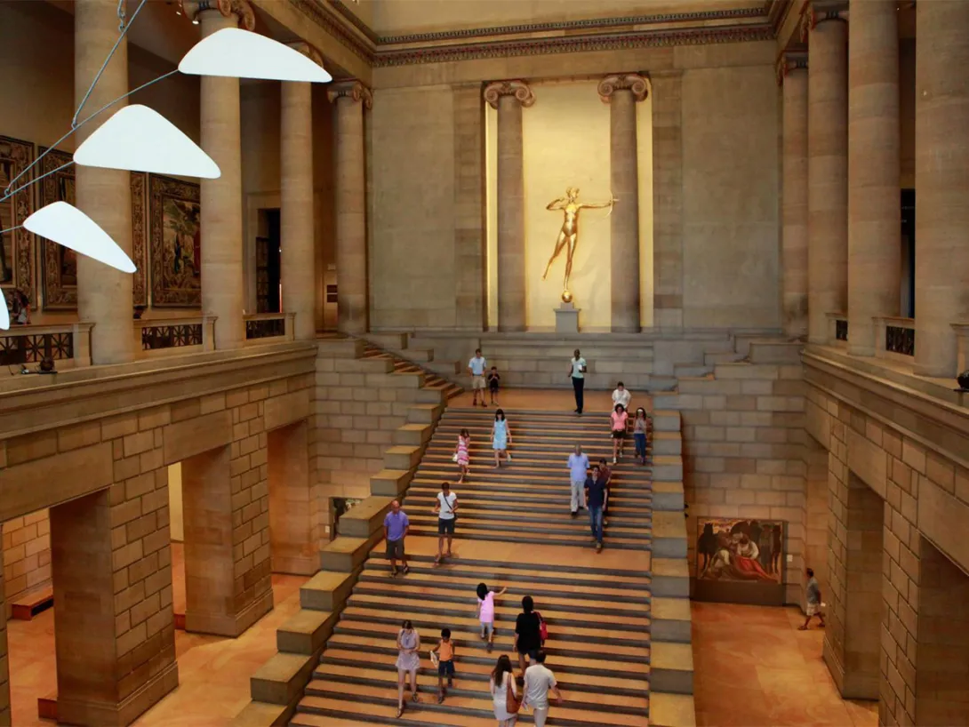 Inside the Philadelphia Museum of Art's main hall showing a large marble staircase